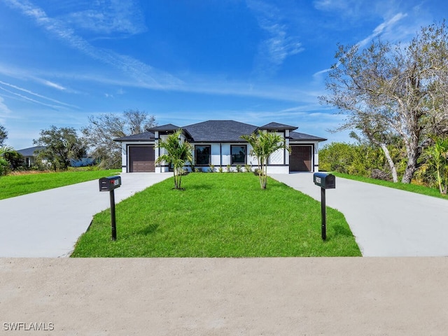 view of front facade with an attached garage, driveway, and a front lawn