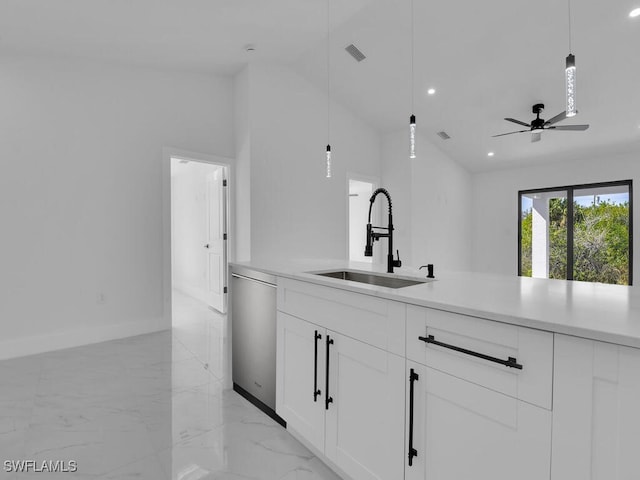 kitchen featuring marble finish floor, pendant lighting, a sink, stainless steel dishwasher, and light countertops