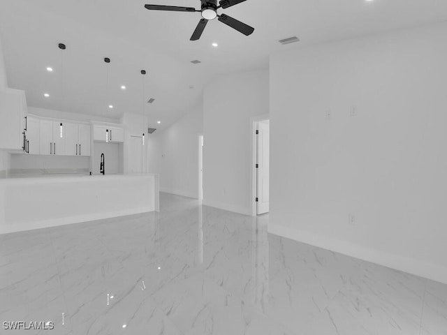 unfurnished living room featuring visible vents, marble finish floor, a sink, recessed lighting, and vaulted ceiling