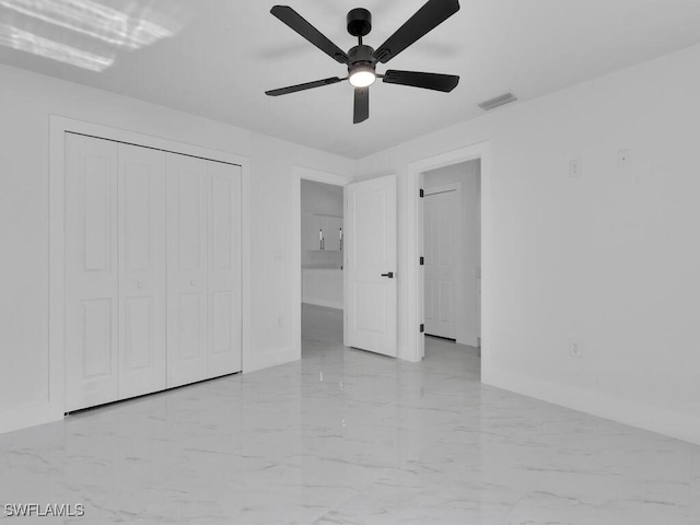 unfurnished bedroom with a closet, baseboards, visible vents, and marble finish floor