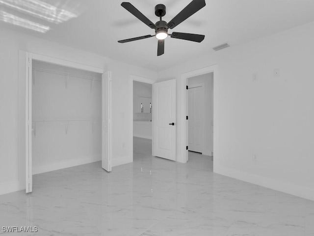 unfurnished bedroom with a closet, visible vents, marble finish floor, and baseboards