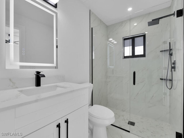 full bath with a marble finish shower, toilet, marble finish floor, and vanity