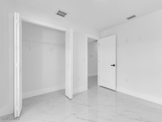 unfurnished bedroom with visible vents, baseboards, and marble finish floor