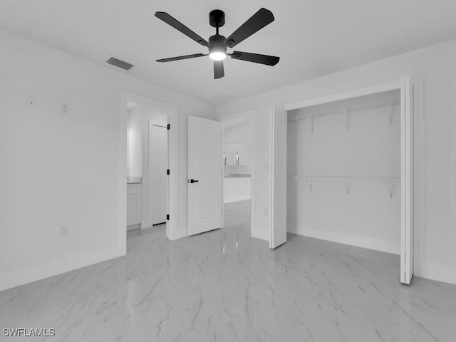 unfurnished bedroom featuring a ceiling fan, baseboards, marble finish floor, and a closet