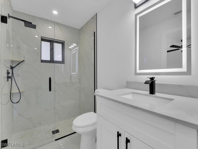 bathroom featuring a marble finish shower, toilet, marble finish floor, vanity, and a ceiling fan