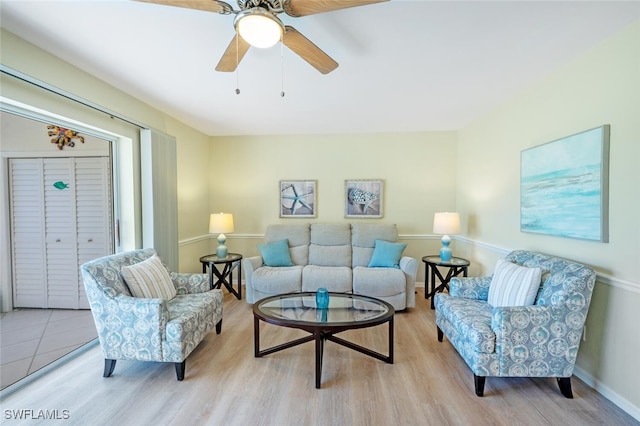 living room featuring light wood-style floors and ceiling fan