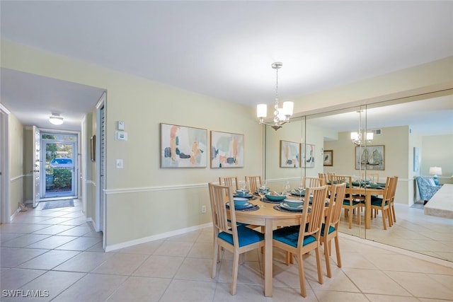 dining space with a chandelier, light tile patterned floors, visible vents, and baseboards