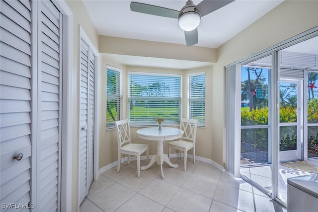 unfurnished sunroom with a ceiling fan