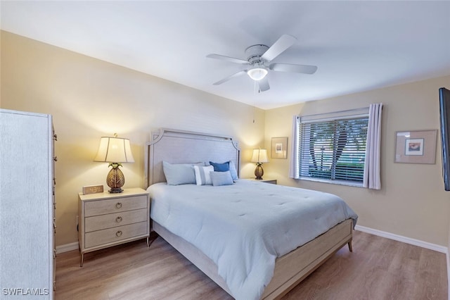 bedroom featuring a ceiling fan, wood finished floors, and baseboards