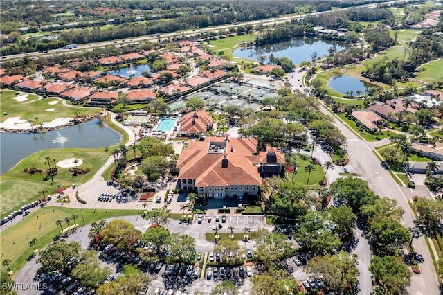 aerial view with a residential view, a water view, and view of golf course