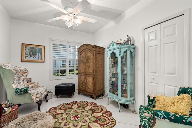 sitting room featuring light tile patterned floors and ceiling fan