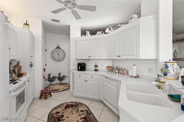 kitchen featuring visible vents, light countertops, light tile patterned floors, white appliances, and a sink