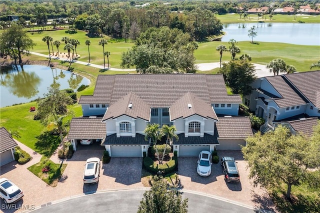 aerial view with golf course view and a water view