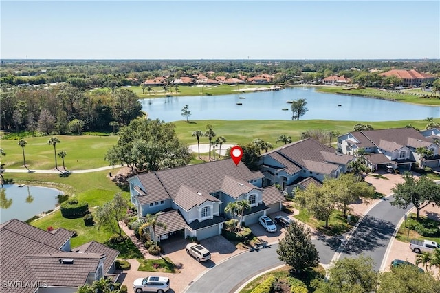 birds eye view of property with golf course view, a water view, and a residential view