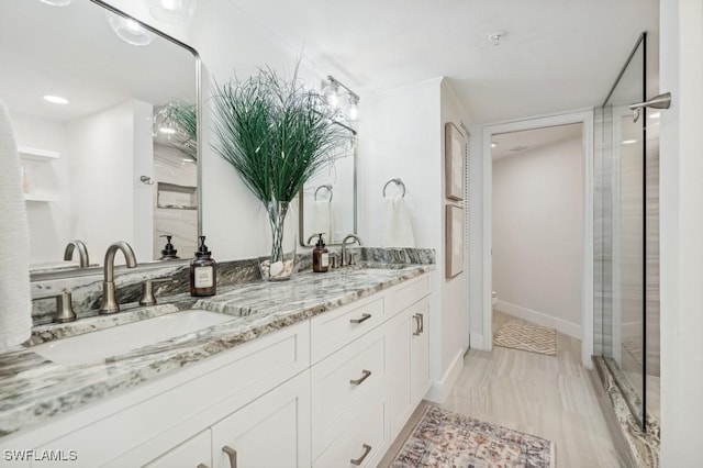 full bathroom featuring a sink, baseboards, toilet, and double vanity