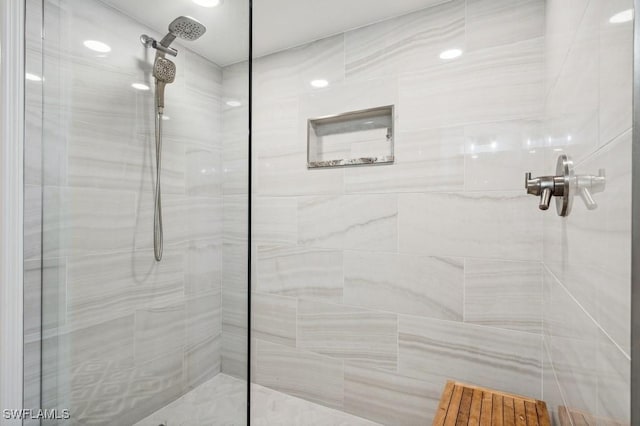 full bathroom with tiled shower