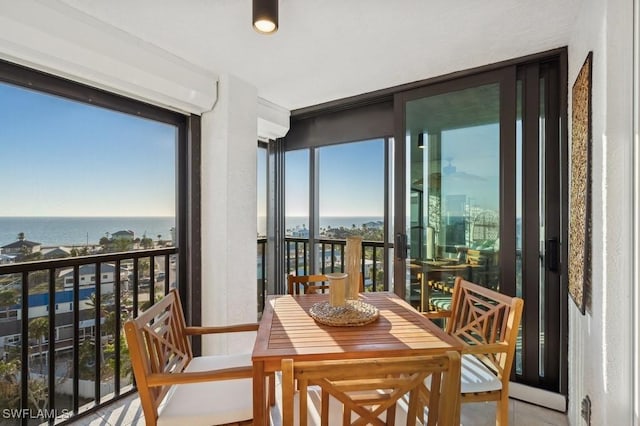 sunroom / solarium featuring a water view