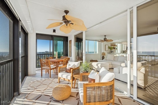 sunroom / solarium featuring ceiling fan