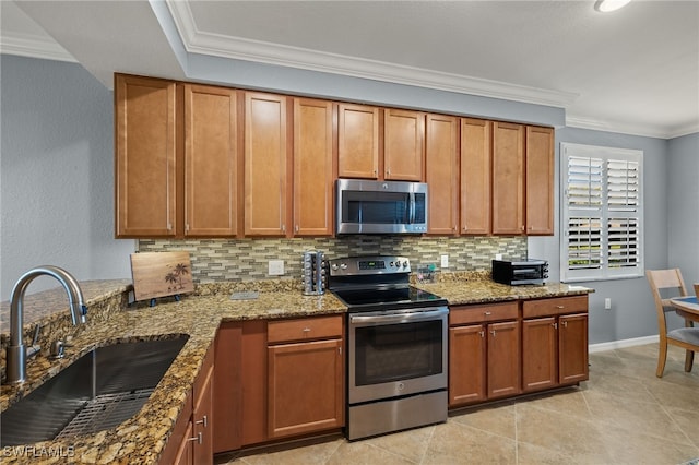 kitchen with a sink, tasteful backsplash, appliances with stainless steel finishes, and crown molding