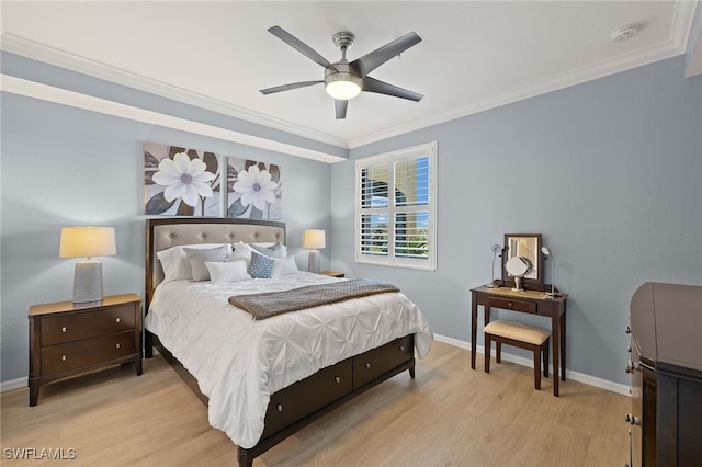 bedroom with baseboards, a ceiling fan, light wood-style flooring, and crown molding