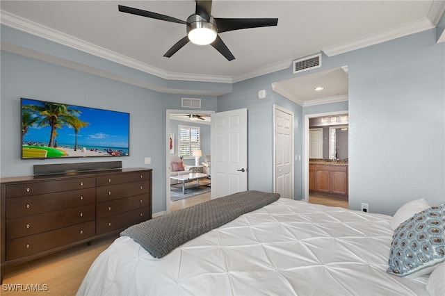 bedroom with visible vents, light wood-style floors, connected bathroom, and ornamental molding