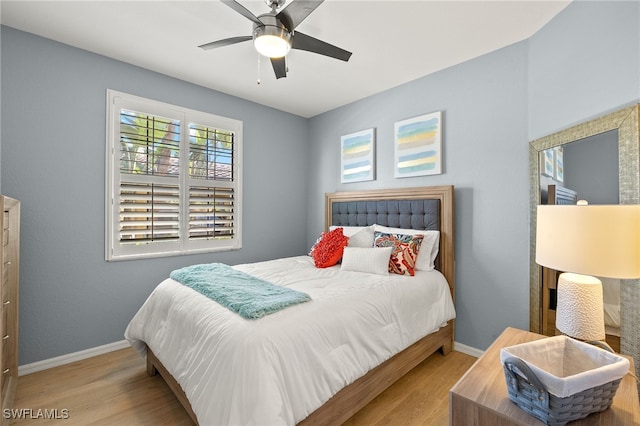 bedroom featuring a ceiling fan, wood finished floors, and baseboards