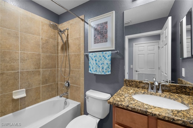 full bathroom with vanity, visible vents,  shower combination, toilet, and a textured wall