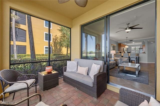 sunroom with a ceiling fan and visible vents