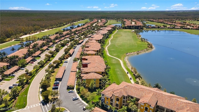 aerial view featuring a residential view, golf course view, and a water view