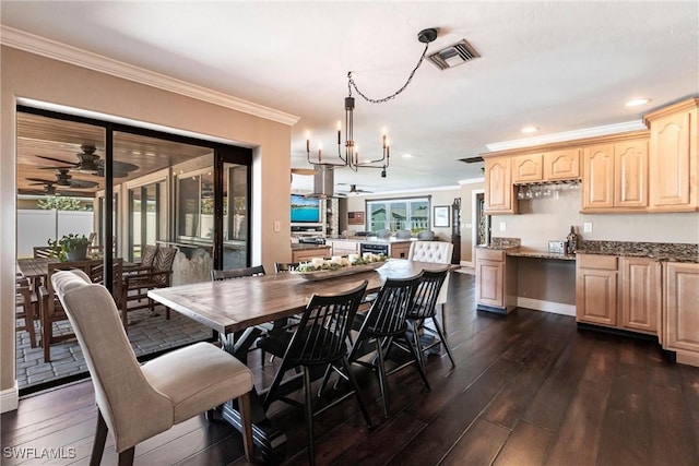 dining area with ceiling fan with notable chandelier, visible vents, dark wood-style flooring, and ornamental molding