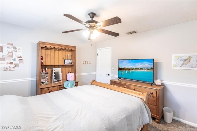 carpeted bedroom with a ceiling fan, visible vents, and baseboards