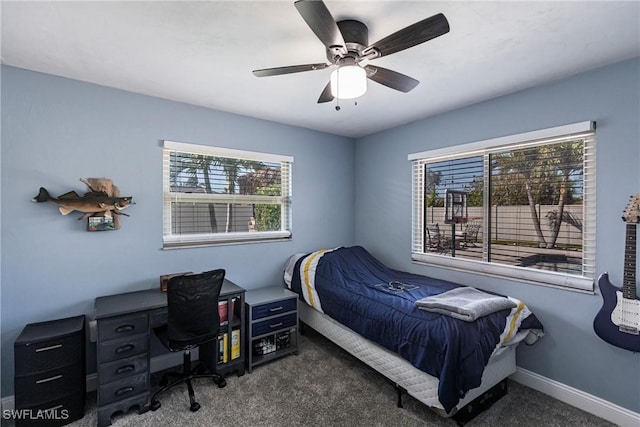 carpeted bedroom featuring baseboards and ceiling fan