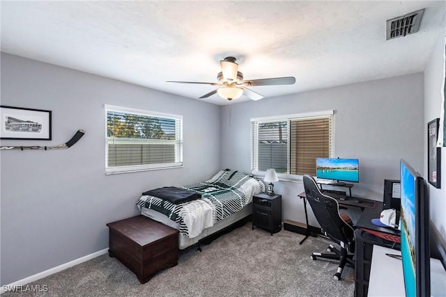 carpeted bedroom featuring visible vents, baseboards, and ceiling fan