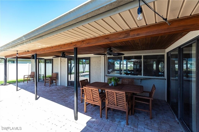 view of patio / terrace featuring outdoor dining area, ceiling fan, and fence