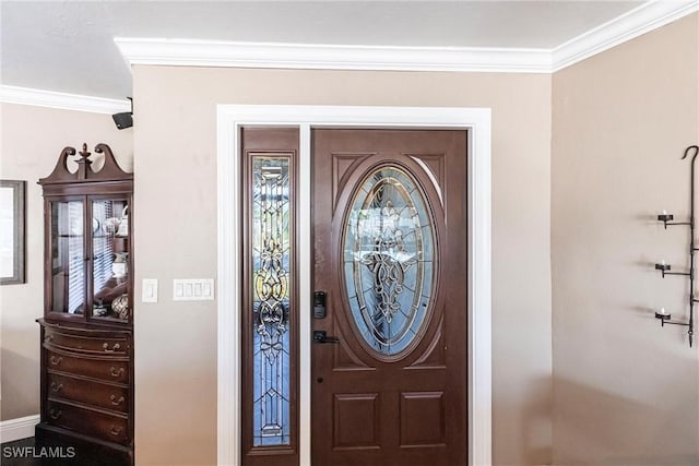 entryway featuring baseboards and ornamental molding