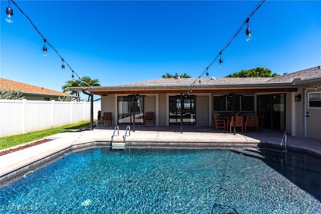 view of pool with a fenced in pool, fence, ceiling fan, and a patio area