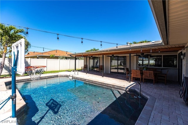 view of swimming pool featuring a fenced in pool, a ceiling fan, a patio, and fence