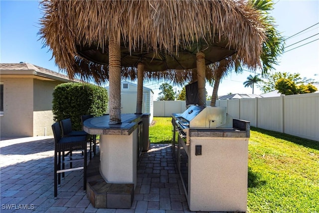 view of patio / terrace with area for grilling and a fenced backyard