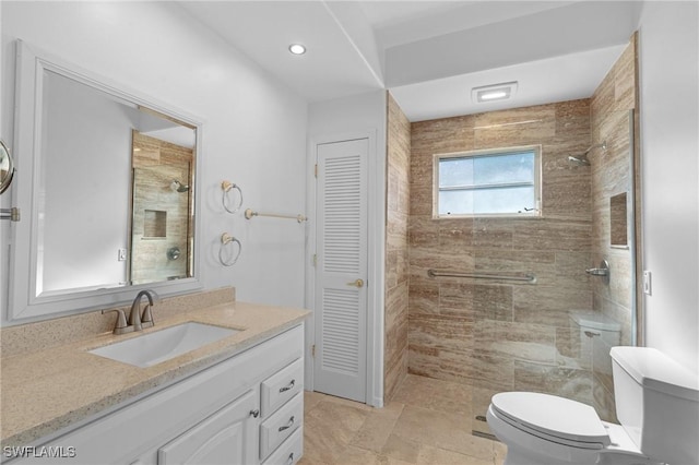 bathroom featuring vanity, tiled shower, recessed lighting, a closet, and toilet