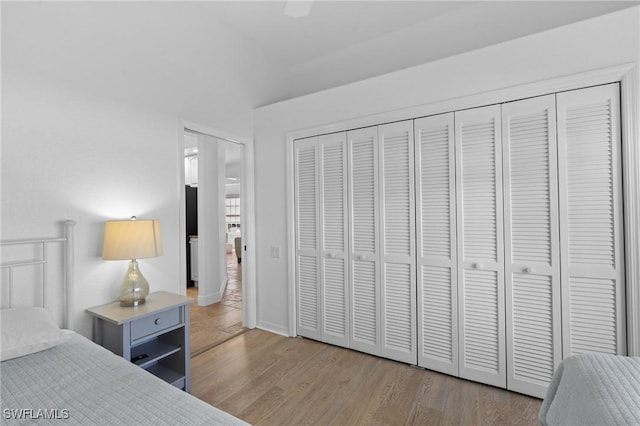 bedroom featuring a closet, a ceiling fan, and wood finished floors