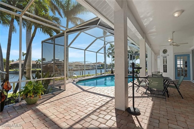 outdoor pool with french doors, a lanai, a ceiling fan, and a patio area