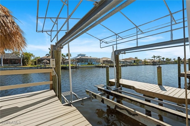 view of dock with a water view and boat lift