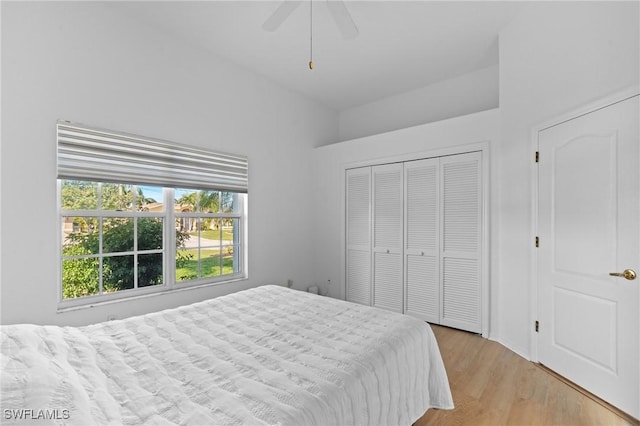 bedroom with a closet, light wood-type flooring, and ceiling fan