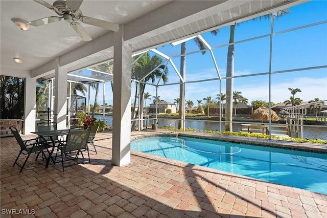 outdoor pool with a patio area, a lanai, and a water view