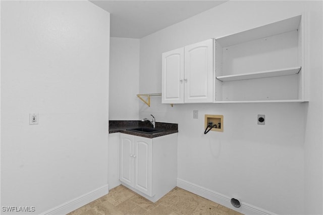 clothes washing area with washer hookup, electric dryer hookup, baseboards, and a sink