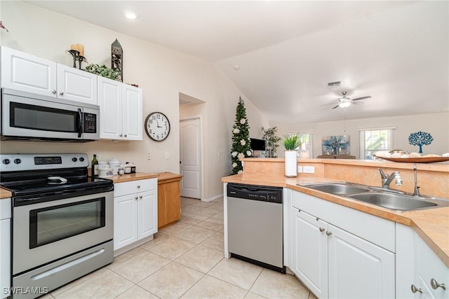 417 NW 3rd Ter, Cape Coral, FL 33993 - kitchen with light countertops, lofted ceiling, appliances with stainless steel finishes, white cabinetry, and a sink