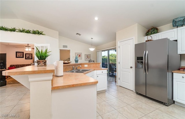417 NW 3rd Ter, Cape Coral, FL 33993 - kitchen featuring lofted ceiling, a sink, light countertops, white cabinets, and stainless steel fridge