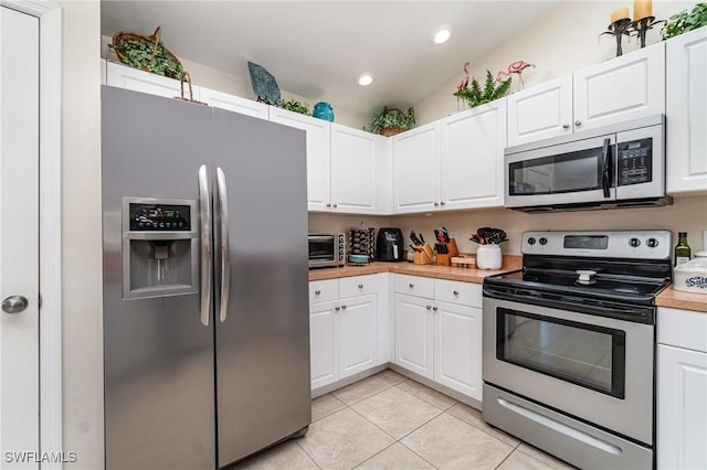 417 NW 3rd Ter, Cape Coral, FL 33993 - kitchen featuring white cabinetry, recessed lighting, stainless steel appliances, light tile patterned flooring, and a toaster