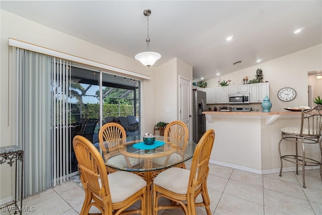 417 NW 3rd Ter, Cape Coral, FL 33993 - dining space with lofted ceiling, light tile patterned flooring, and recessed lighting