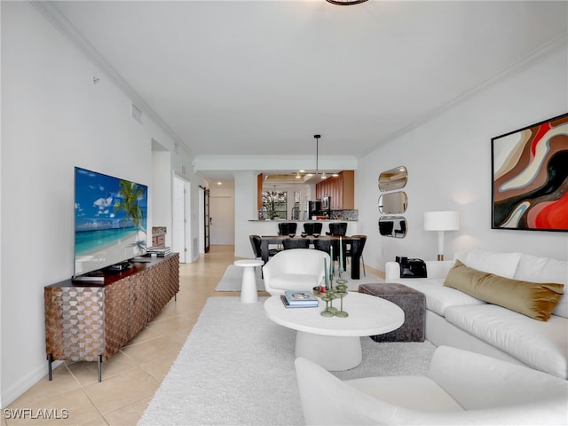 living area with light tile patterned flooring, visible vents, baseboards, and ornamental molding